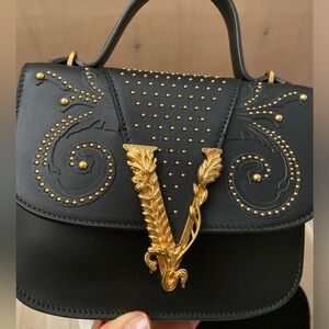 Black Versace with gold studs and hardware shoulder bag